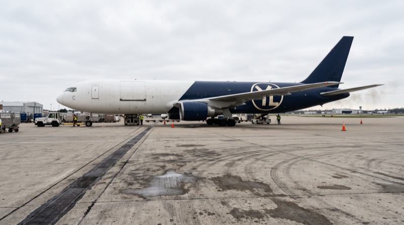 Conceptual YASLOGIST-branded cargo aircraft parked at an air terminal