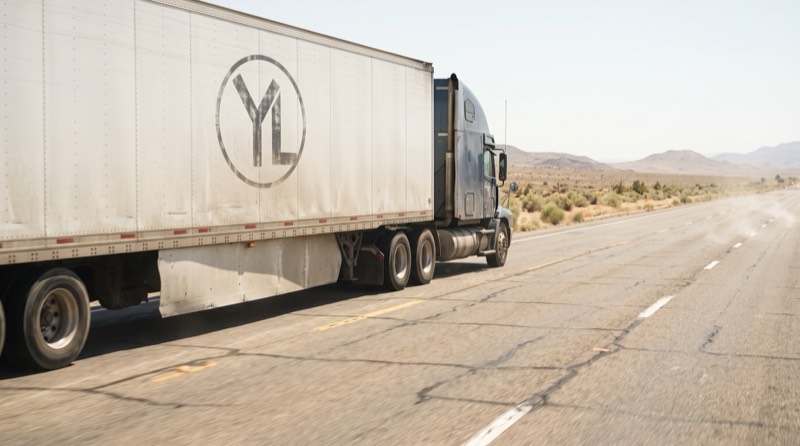 Conceptual truck travelling on a desert highway during an inland freight leg